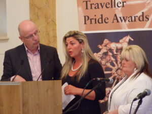 The Spring Lane Halting Site Community receiving the Traveller Pride Community Award.  